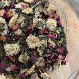 Image of chrysanthemums, rose and other Pitta tea ingredients in a glass jar
